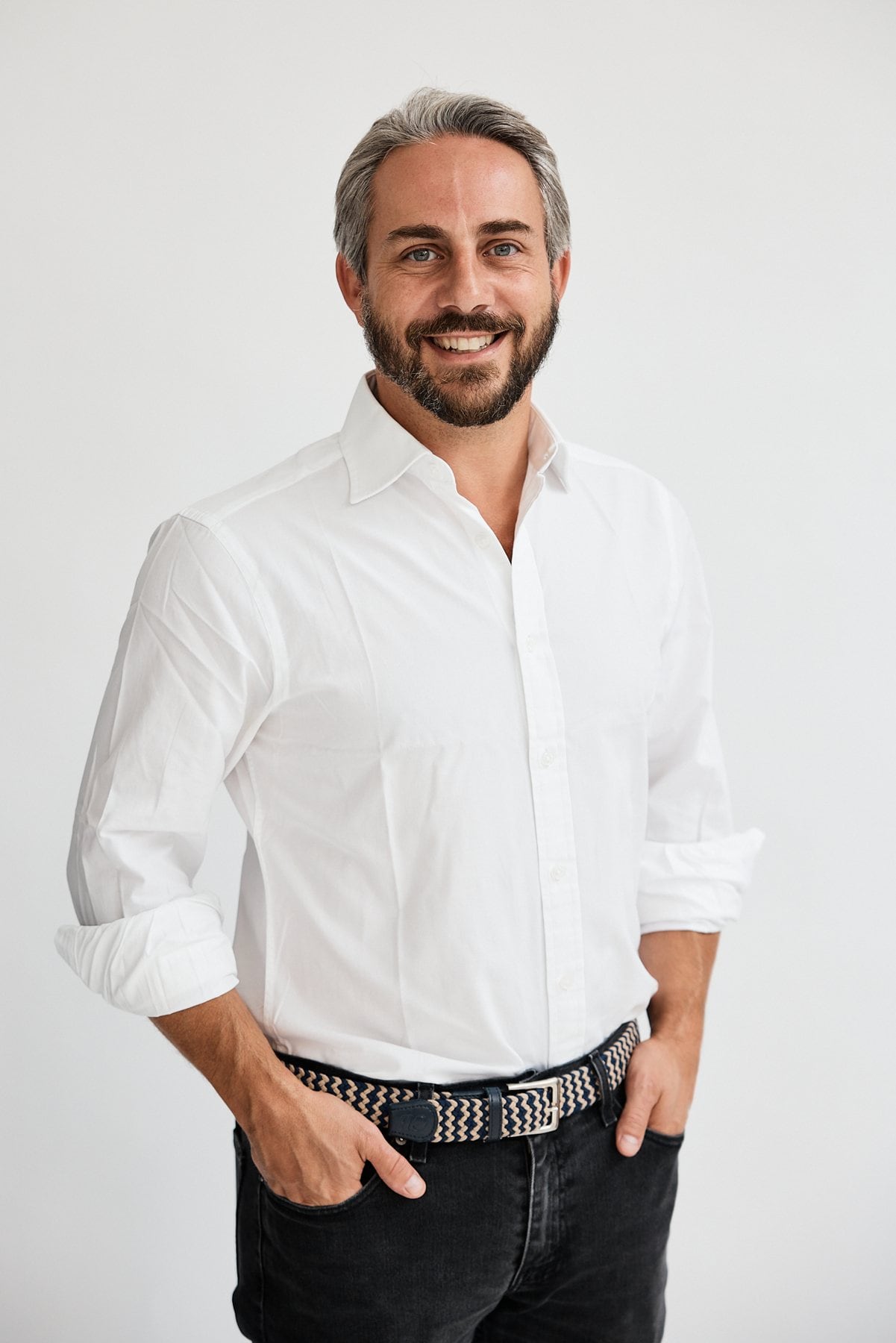 Sam Merullo, smiling, in a white shirt